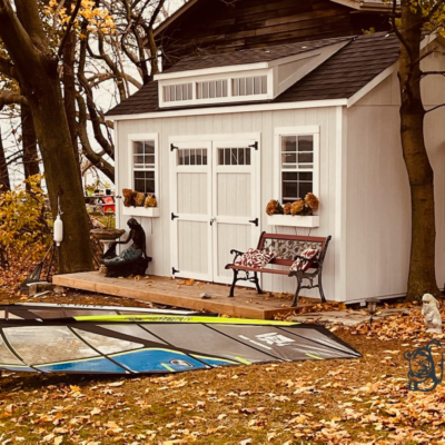 Utility Shed 10x16, 2x3 windows, Double Barn Doors With Windows, White Siding, Dormer, and Black Shingles.