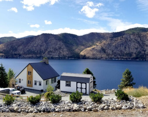 Lofted Barn 10x16, 3x3 windows, Double Barn Doors, White Siding, and Burnished Metal Roof.